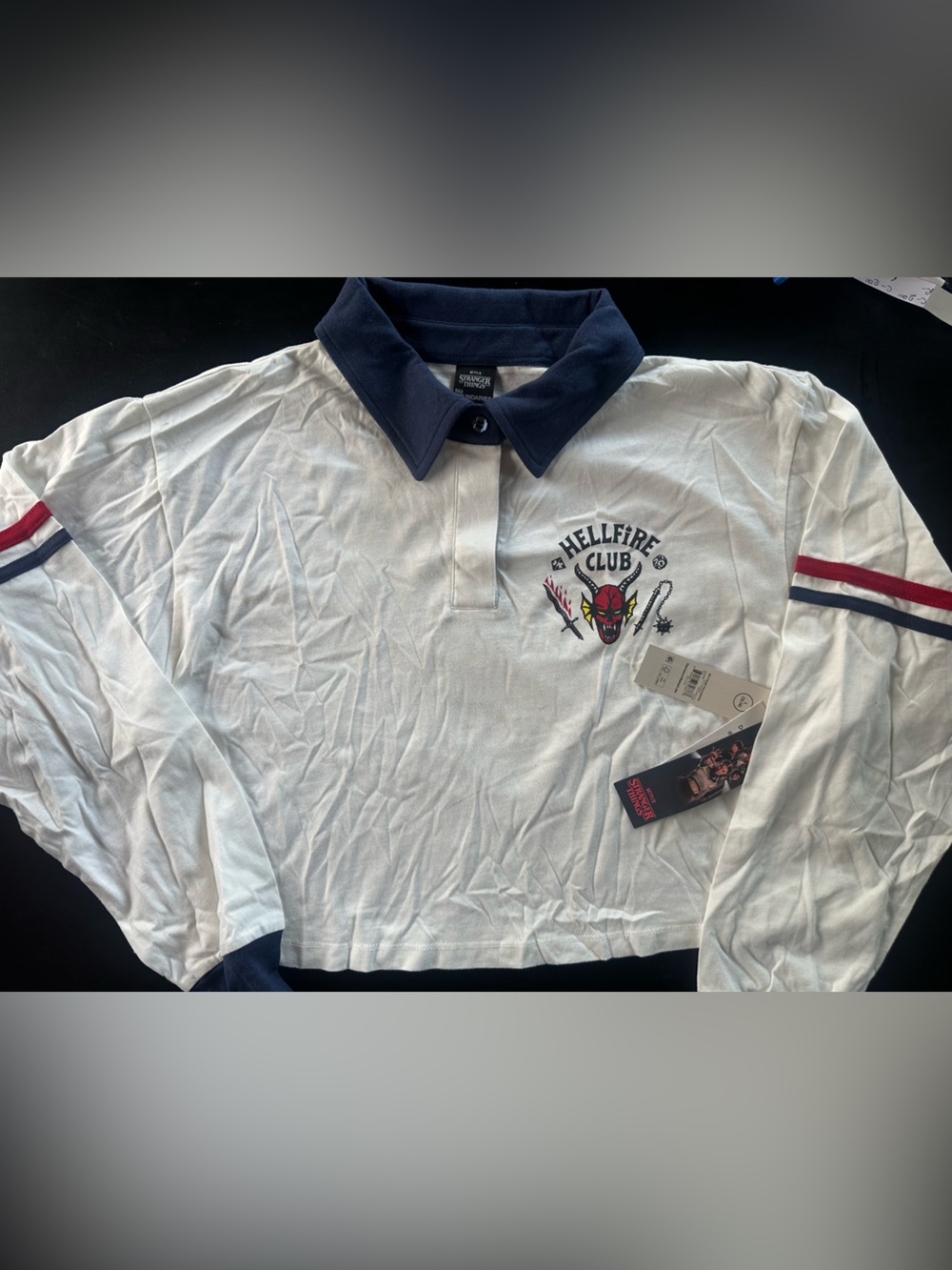 Netflix “Stranger Things” White Polo Shirt with Navy Collar and Red Stripe